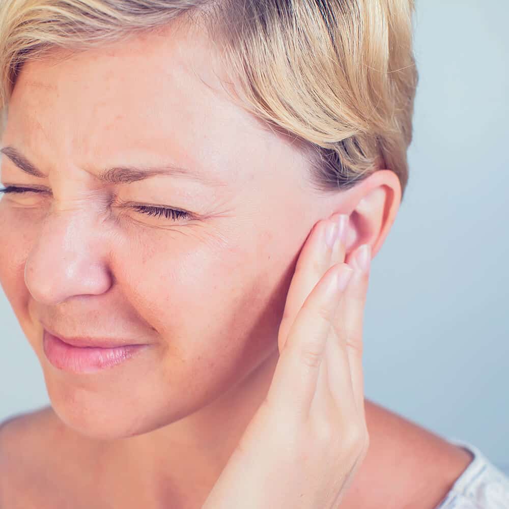 woman suffering from tinnitus